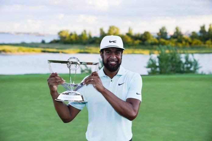 Tony Finau poses with The Northern Trust trophy after beating Cameron Smith in the playoff at Liberty National on Monday. Photo: Deseret News